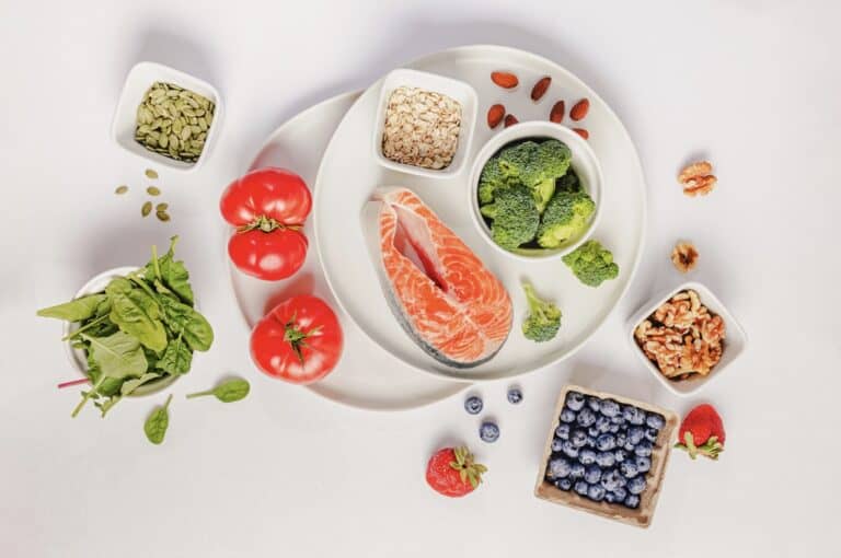 A plate of low inflammatory diet with salmon, blueberries, and vegetables